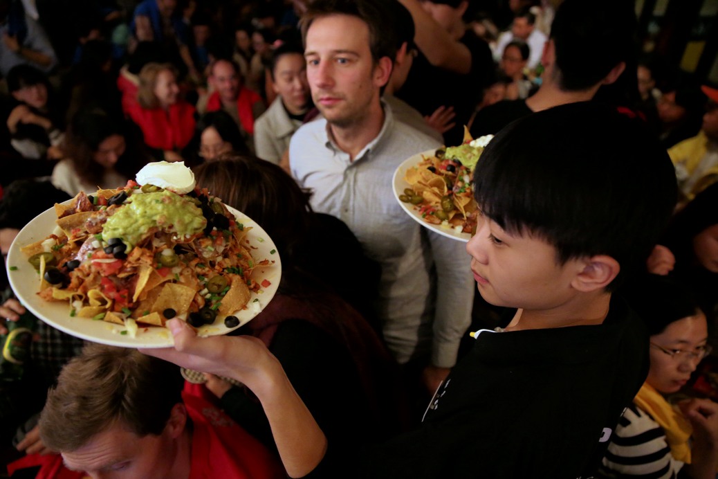 Constantine's eye is fixed on the tasty plates of food carried past by the underage waiter. Photo by EURAXESS