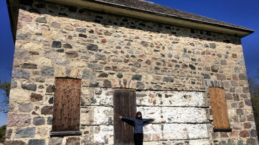 2015-05-18_1027 EDIT 1200px | J takes a photo by the walls of the stone house that has stood for decades.